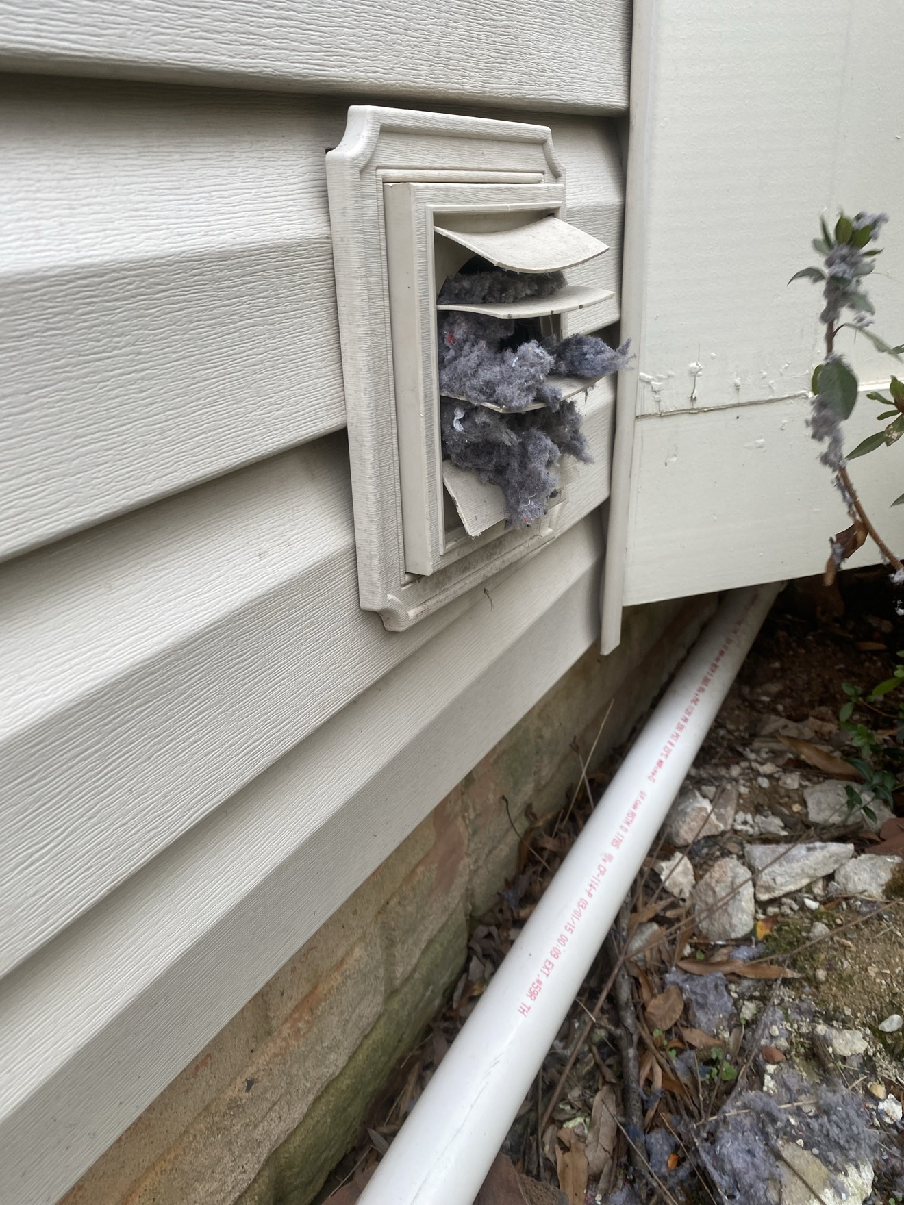 Exterior dryer vent cover clogged with lint