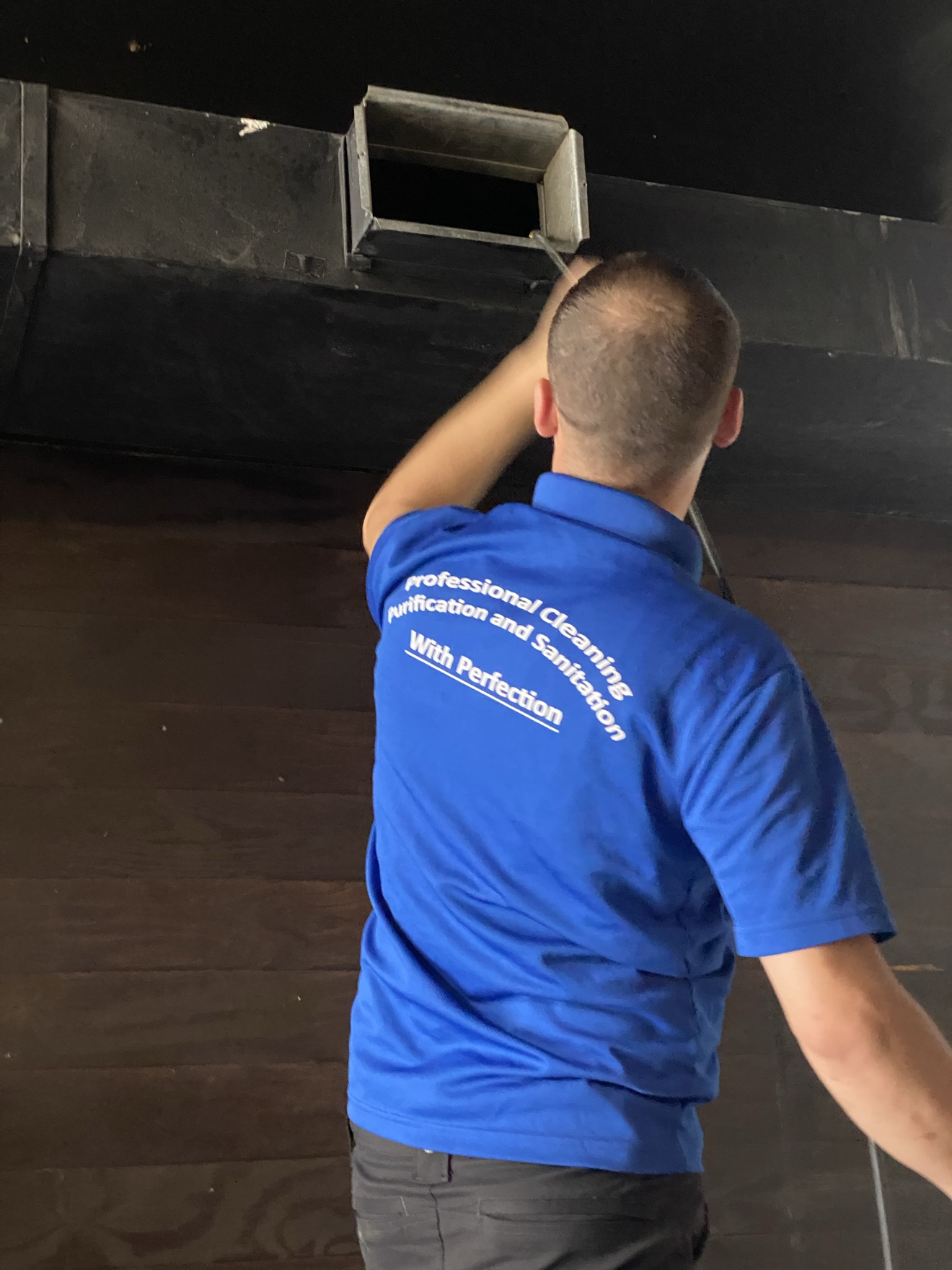 Technician removing a vent cover during air duct cleaning